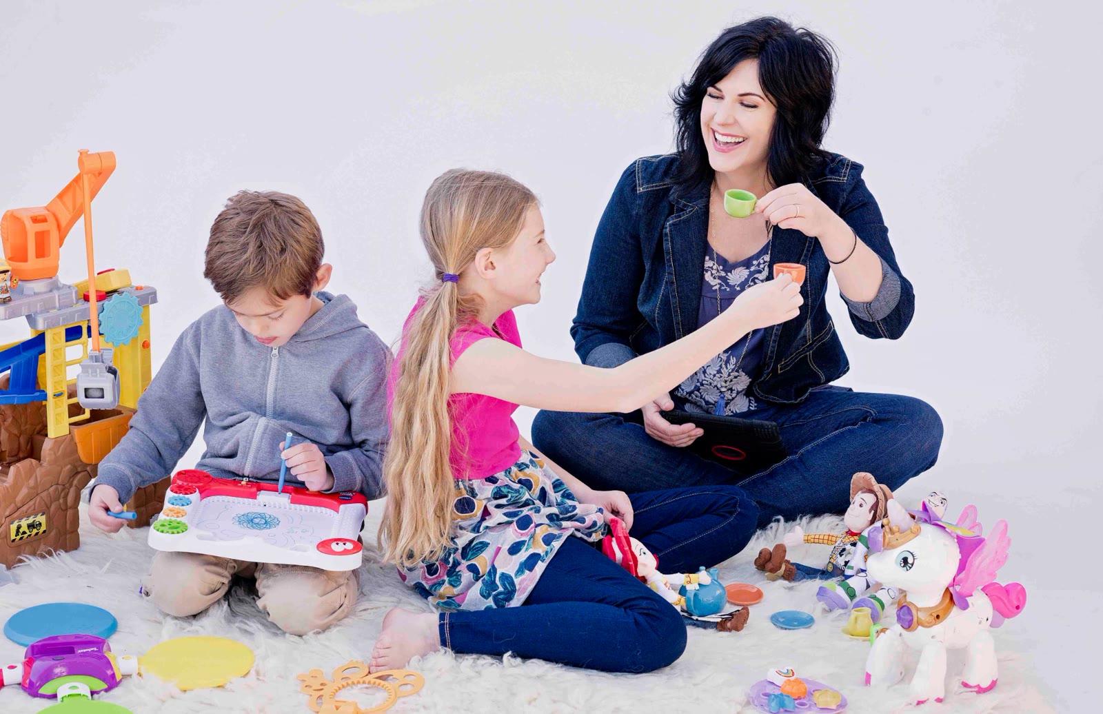 Jennifer Knight with her children surrounded by toys they have voiced